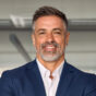 Handsome hispanic senior business man with crossed arms smiling at camera. Indian or latin confident mature good looking middle age leader male businessman on blur office background with copy space. Handsome hispanic senior business man with crossed arms smiling at camera. Indian or latin confident mature good looking middle age leader male businessman on blur office background with copy space.